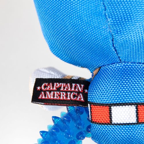 Close-up of the 'Captain America' label on the dog toy, showing clear branding and stitched detail on the fabric tag.