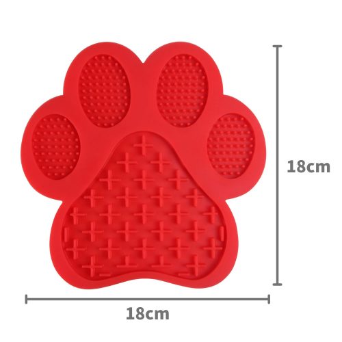 Red paw-shaped dog lick mat made from durable silicone with multiple textures to engage and soothe dogs.