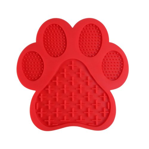 Red paw-shaped dog lick mat made from durable silicone with multiple textures to engage and soothe dogs.