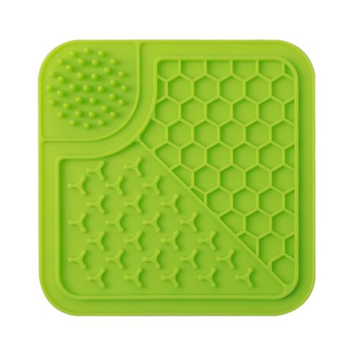 Green silicone dog lick mat designed to reduce anxiety and promote relaxation, featuring strong suction cups for secure placement.