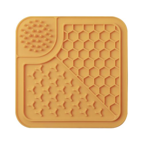 Orange silicone dog lick mat perfect for stress relief and mental stimulation, equipped with strong suction cups for stability during use.